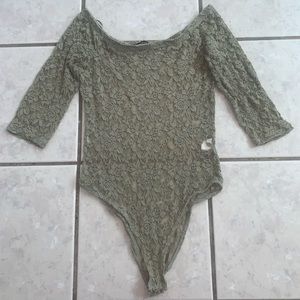 Olive green lace bodysuit. It has a small stain (in the photo you can see it).